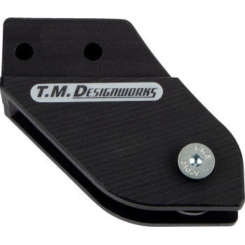 The Yamaha Chain Guide Black by T.M. Designworks is a black plastic rear chain guide slider with UV protection, gray brand logo, two mounting holes, angled edges, and a silver screw.