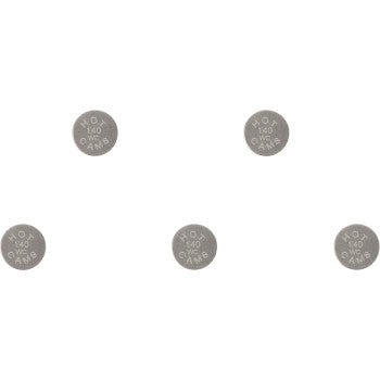 Five small, round gray metal valve shims engraved with 9.48 x 1.40 dimensions arranged in a scattered pattern.