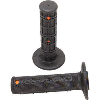Two black 799 Gel Cross Grips by Pro Grip with orange dots, textured surfaces for better grip and less vibration. One grip stands upright and the other lies flat, both showing PROGRIP branding.