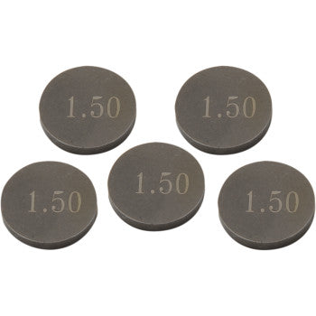 Five round dark gray metal valve shims engraved with "1.50" on top, flat and thin discs.