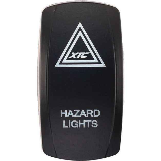 A black Dash Switch Rocker Face for hazards by XTC Power featuring a white triangle symbol labeled XTC and HAZARD LIGHTS printed below in white text.
