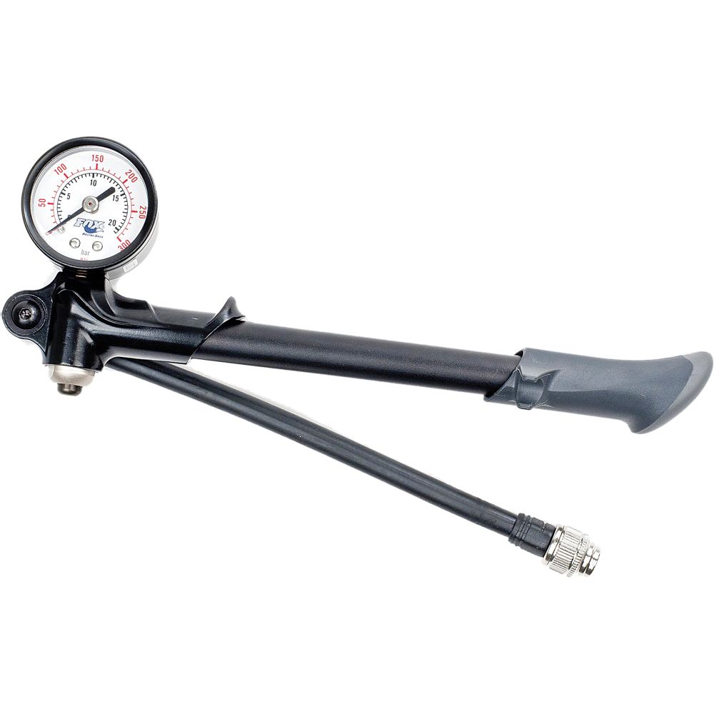 The Dual Sided Shock Pump 300Psi Max by Fox is a black handheld pump with a gauge, flexible hose, bleed valve, and silver nozzle, designed for inflating suspension forks and FOX FLOAT shocks. The gauge displays up to 300 PSI.