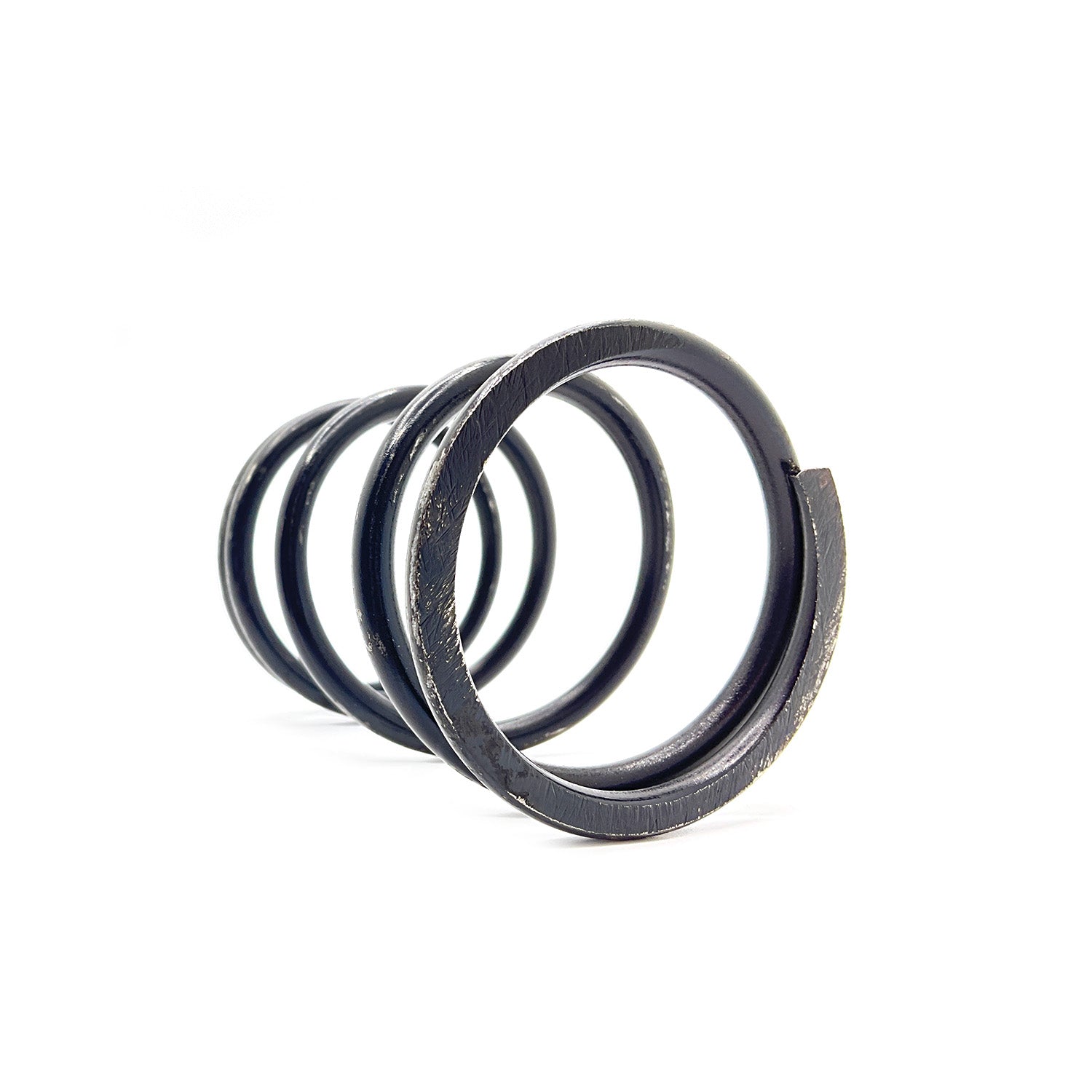 Black metal coil clutch spring with four loops and a slightly textured surface.