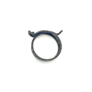 Black metal spring band clamp with small locking tab, circular shape, smooth finish.