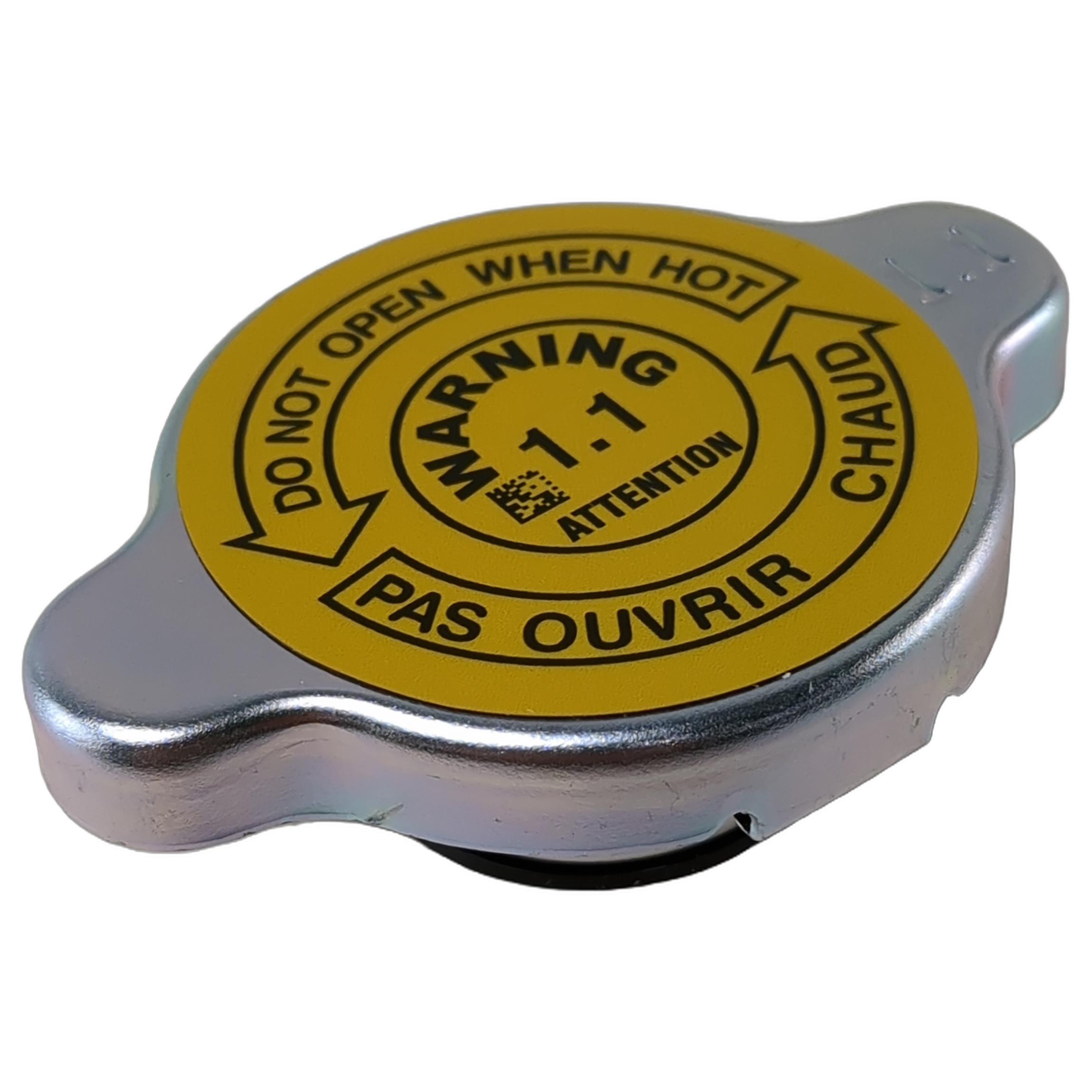Silver metal radiator pressure cap with a yellow warning label and safety instructions on top.