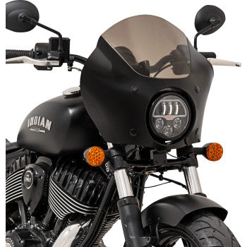 Close-up of a black Indian Chief motorcycle with a Gauntlet Fairing by Memphis Shades, tinted windshield, round headlight, orange turn signals, visible logo on the tank, plus handlebars and side mirrors in view.