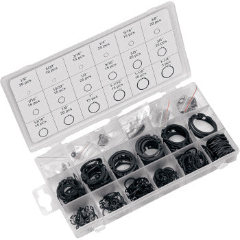 The Snap Ring Assortment 300 Piece by Performance Tool comes in a clear resealable case with labeled compartments, assorted snap rings and tools for sealing and repairs, plus a lid chart showing sizes and quantities.