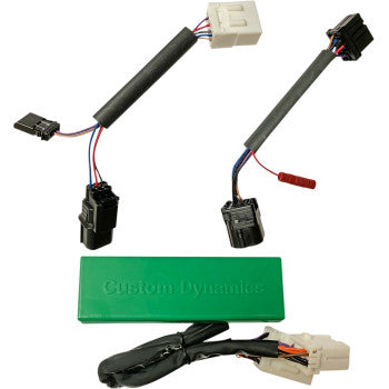 The Honda Triple Play Module by Custom Dynamics is shown with plug and play connectors in a green rectangular case, displayed on a white background—perfect for enhancing rear brake lights or customizing brake flash patterns.