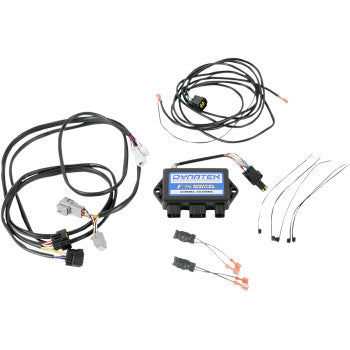 The Kawasaki Programmable Ignition System by Dynatek includes a central electronic module, multiple black cables, and connectors to boost spark energy, all shown on a white background.