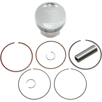 Silver metal piston with engraved text, accompanied by various circular piston rings and a cylindrical pin arranged on a.