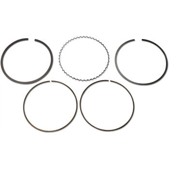 Set of five dark metal piston rings, including compression and oil control rings, arranged on white background.