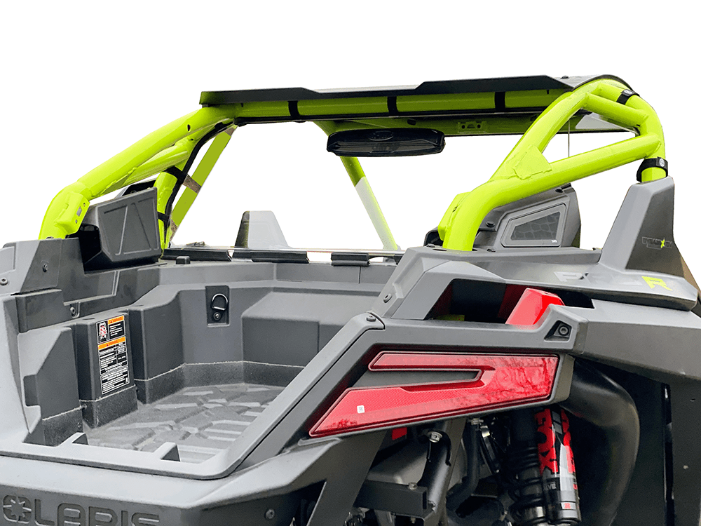 A close-up rear view of a gray and neon yellow off-road vehicle with an open cargo bed, roll cage, visible suspension, and a Polaris Pro-R Vented Hard Coated Rear Windshield by Spike for enhanced off-road protection against debris. White background.