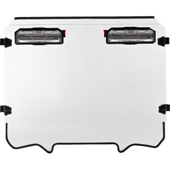 The Polaris RZR Vented Windshield by Seizmik features a white metal panel with four black latches, two rectangular clear lights near the top, and a curved bottom cutout for a weather-tight, durable seal.
