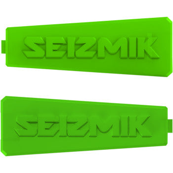 Pair of bright green rectangular plastic inserts with raised Seizmik logo and notch on one edge.