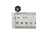 Black hexagonal nylon lock nut next to white ruler showing size just under 0.5 inch.