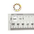 Small circular washer lock with internal teeth, metal with a yellow-gold finish, next to ruler showing about 0.