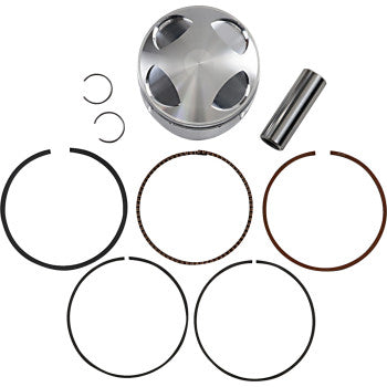 Polished silver metal piston with curved top, wrist pin, circlips, and six black and copper piston rings arranged below.