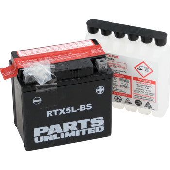 A Parts Unlimited AGM Battery RTX5L-BS .24L in black is displayed with its sealed acid pack beside it, both featuring visible warnings and safety instructions.