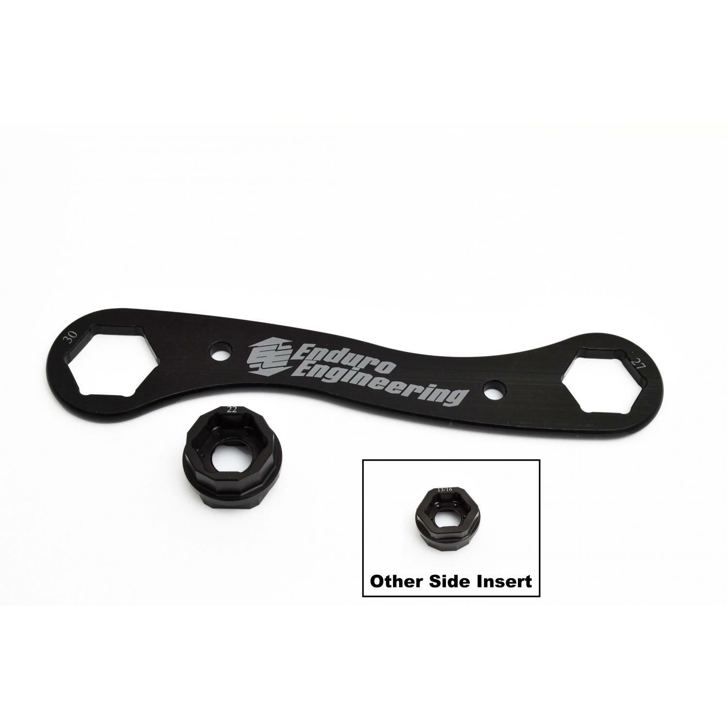 The Trail Multi Tool 22 27 30Mm by Enduro Engineering is a black billet aluminum axle wrench with two hexagonal openings and an included insert; an inset image labeled "Other Side Insert" displays the insert’s opposite side. Durable and lightweight.