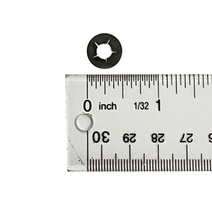 Black metal retainer bolt 1/4-20 with star-shaped internal design next to clear ruler showing size.