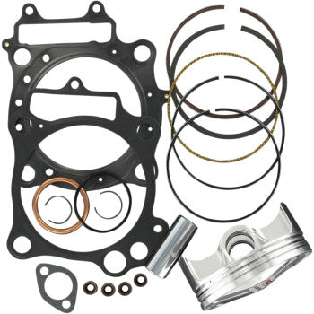 Set of black engine gaskets with silver piston and metal piston rings arranged on white background.