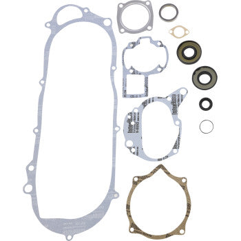 The Kawasaki - Suzuki Gasket Kit Complete by Prox includes top-quality gaskets and seals for engine rebuilds, such as an elongated gasket, multiple circular and irregular-shaped gaskets, valve stem seals, and assorted rubber seals.