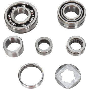 The Transmission Bearing Kit by Hot Rods is arranged on a white background, showcasing its various shapes and internal structures, including output shaft collars, ball bearings, and cylindrical roller bearings.