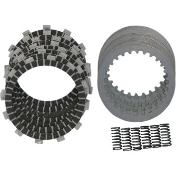 Stack of black clutch friction plates, gray metal clutch plates, and several small coil springs arranged neatly on white.