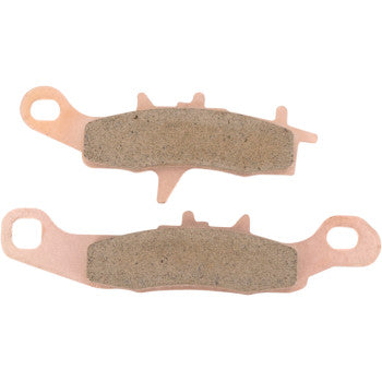 Two copper-colored metal brake pads with textured gray friction surfaces designed for offroad use.