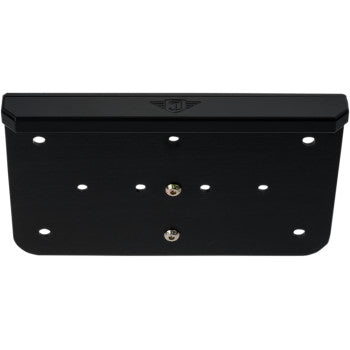 The License Plate Mount Black by Joker Machine is a black, rectangular CNC-machined aluminum bracket with multiple mounting holes and a small emblem at the top center. Its matte finish adds durability, ideal for pairing with a waterproof license plate light.