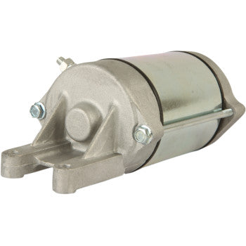 Compact silver metallic starter motor with two mounting holes and electrical connectors on offroad vehicle use.