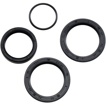 Four black seals from the Polaris Differential Seal Kit Front by Moose Offroad are arranged on a white background. Each circular seal has ridged edges and size numbers, perfect for differential service or high-speed EMQ bearings.
