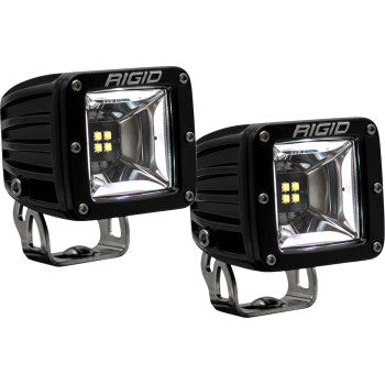 Two black, square-shaped Light Pods RGBW Surface Mount by Rigid Industries, shown side by side with metal mounting brackets and RIGID branding, feature advanced voltage protection for reliable off-road performance on any terrain.