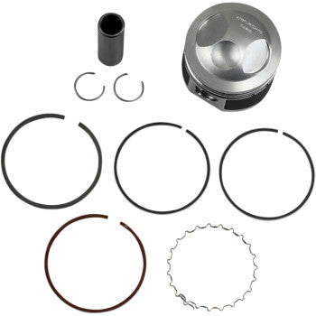 The Yamaha Piston Kit 54.00 mm by Wiseco is displayed on a white background, including a metal piston, wrist pin, two circlips, and five assorted piston rings neatly arranged.