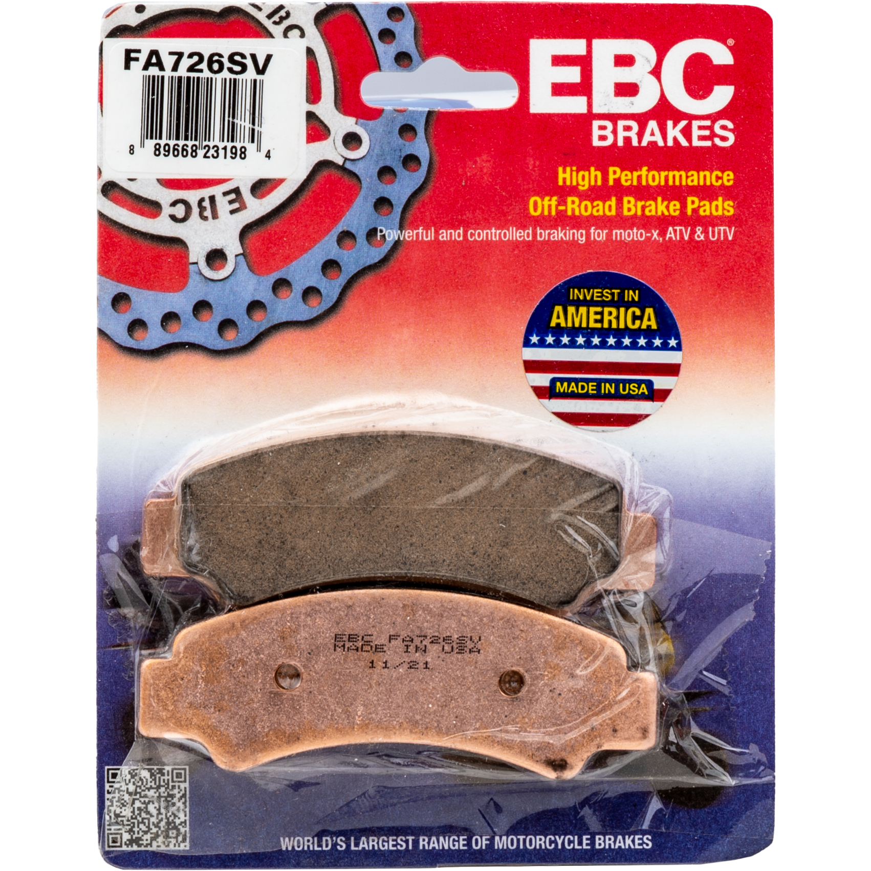 Set of two rectangular motorcycle brake pads with copper-colored backing plates and dark friction surfaces, packaged beneath