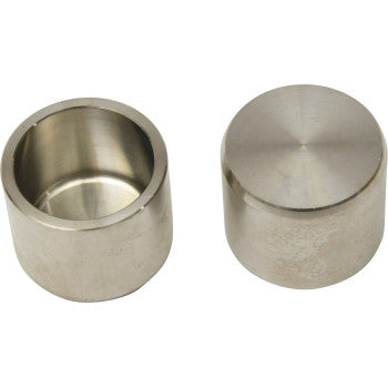 Two cylindrical metal objects, both Brake Caliper Pistons by All Balls, are shown—one upright with a closed top, the other revealing its hollow interior. Both have a smooth metallic finish and are precision machined from high grade 304 stainless steel.