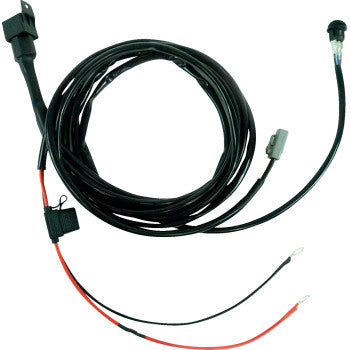 The Wire Harness Dual Light Low Power by Heretic is a black, coiled electrical harness with connectors and red/black wire ends fitted with metal ring terminals. It includes a fuse for protection and is ideal for Plug-and-Play light setups.
