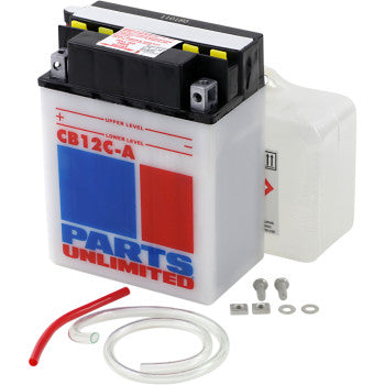 The Battery YB12C A by Parts Unlimited features white casing with red and blue graphics, providing reliable cranking power. Shown with clear acid container, red/clear tubing, and small mounting hardware on a white background.