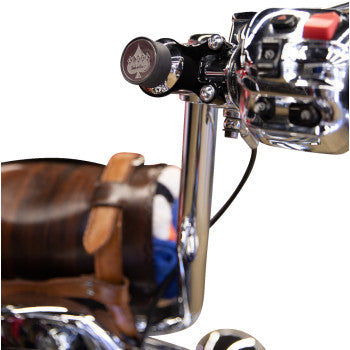 Close-up of a shiny chrome scooter handlebar with control buttons and the Ambidextrous Mount - iOmount™ - Black by Klock Werks, plus a brown leather seat visible in the background.