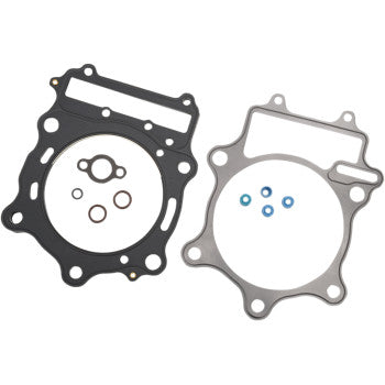 The Suzuki Top End EST Gasket Kit 106 mm by Cometic includes a black Extreme Sealing Technology gasket, a metallic gray gasket, and five small circular seals in various sizes, displayed on a white background.