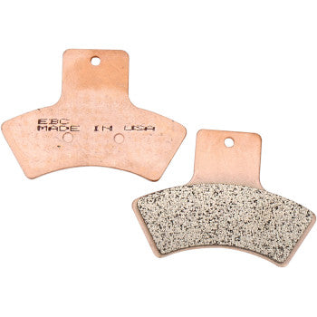 Two copper-colored SV Severe Duty Brake Pads by EBC are shown. One displays a textured friction surface for long pad life; the other features stamped text EBC MADE IN USA. Both pads have small holes near the top edge.