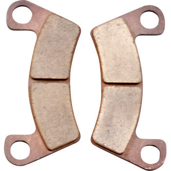 Two Textron Sintered Brake Pads by Dp Brakes with rectangular friction surfaces and copper-colored curved backing plates, each with two circular mounting holes. These premium ATV pads are shown side by side, facing outward.