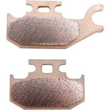 Two KingQuad Standard Brake Pads by Dp Brakes with copper-colored sintered metal surfaces and sturdy metal backing plates, displayed horizontally—suitable for bikes or as ATV brake pads.