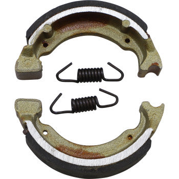 Brake Shoes by Dp Brakes: Two semi-circular metallic shoes with black friction lining and two coiled metal springs, shown on a plain white background, deliver reliable fade-free braking performance.