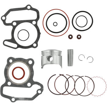 Silver metal piston with matching cylindrical pin, black and red gaskets, and multiple piston rings arranged on a white.