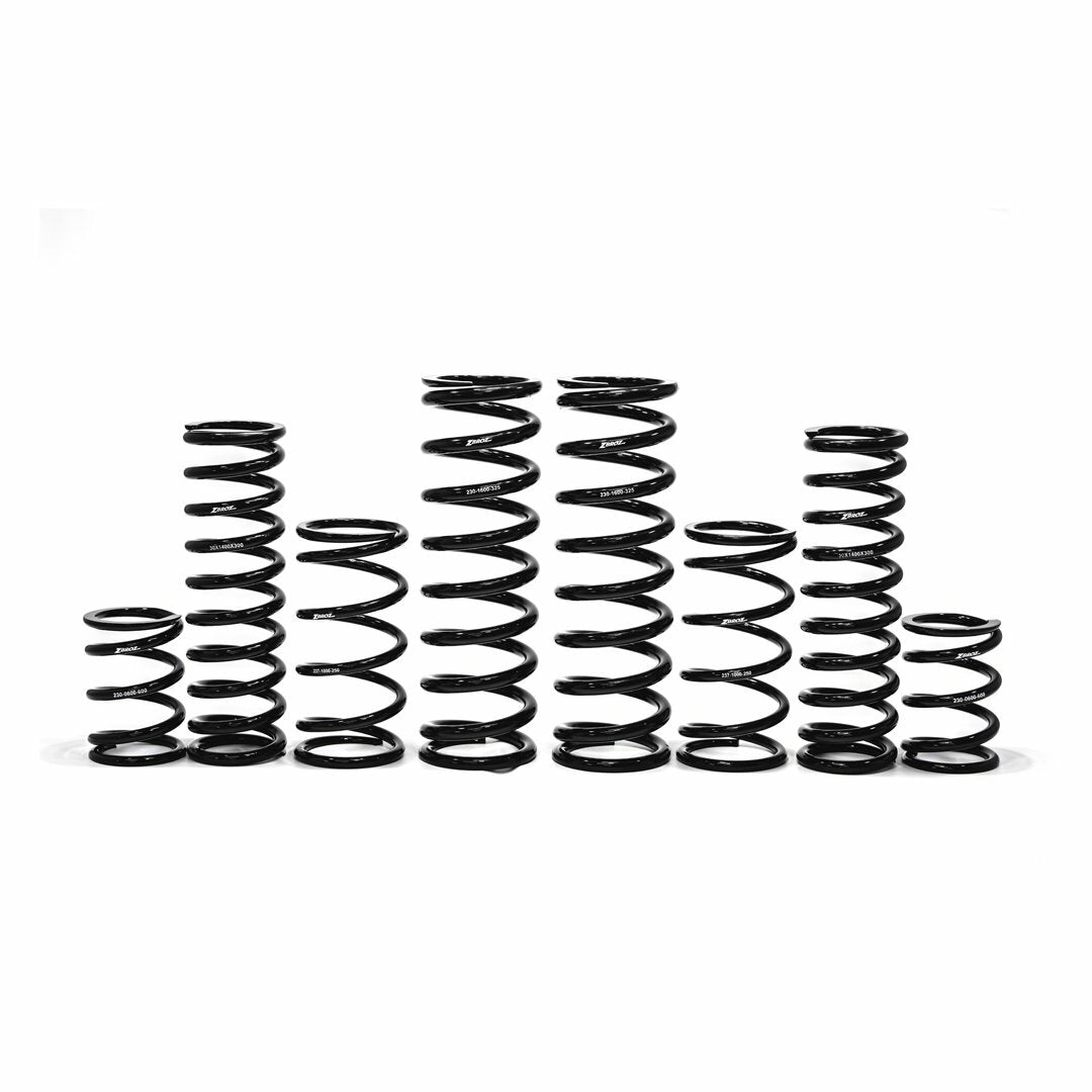 The Can-Am Dual Rate Spring Kit 72 by ZBroz features seven black metal coil springs of different heights and thicknesses, arranged in a row, engineered for enhanced bottoming resistance and optimal ride height on a white background.