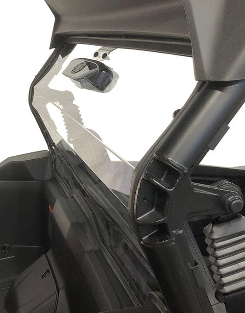 A close-up side view of the Spike CFMOTO Z-Force 800 / 950 Gen 2 Rear Vented Windshield installed on a black off-road vehicle, showcasing part of the interior and roll cage for added protection.