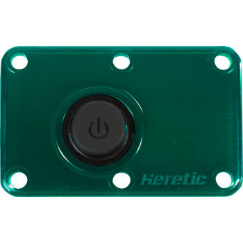 A green rectangular Lens Dome Light by Heretic with four corner holes and a central black power symbol. "Heretic" is printed in white in the bottom right, making it an ideal replacement lens for your Heretic Dome Light.