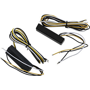 Three black rectangular LED Converter Amber units by Custom Dynamics with coiled black, white, and yellow wires are shown on a white background. Each features exposed wire ends, perfect for your amber turn signal or white running light setup.