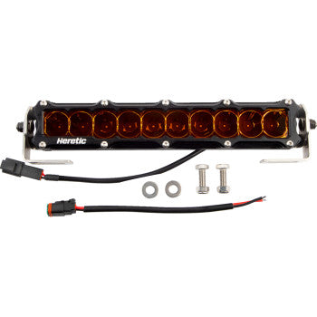 The Light Bar 10" Spot Amber by Heretic is a rectangular LED bar with an amber lens, stainless steel mount, screws, washers, and wiring connectors. All items are shown on a white background.